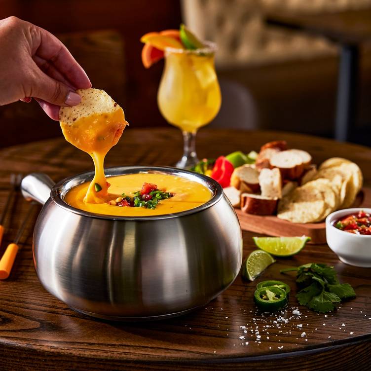 The Melting Pot signature dishes The 4-Course Experience, Classic Alpine Cheese Fondue, Yin & Yang Chocolate Fondue
