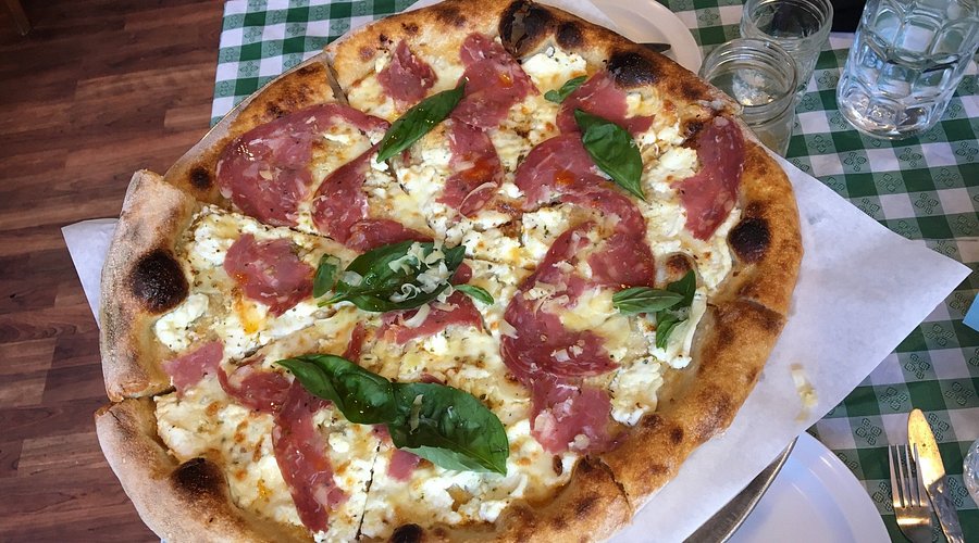 Driftwood Oven signature dishes Classic Cheese Pizza, Bianca Pizza, Pepperoni Roll, Pepperoni Pizza, seasonal specialty pizzas.