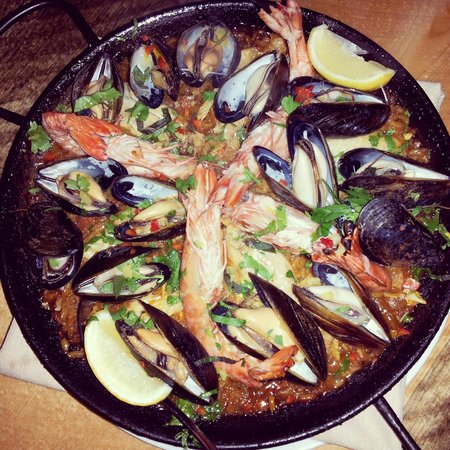 Cafe Aion signature dishes Paella, Patatas Bravas, Bacon-Wrapped Dates, Tagine